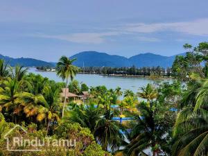 a view of a body of water with palm trees at RinduTamu Homestay in Lumut