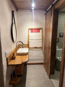 a bathroom with a sink and a mirror at Chalé do vale in Lavras Novas +36 photos