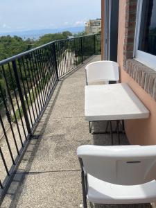 a white table and two chairs on a balcony at Casitas Las Palmas - Coral de Mar in Punta Mita