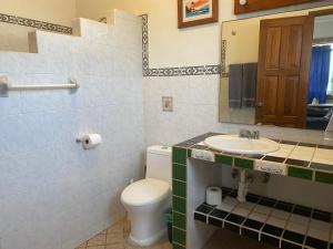 a bathroom with a toilet and a sink at Casitas Las Palmas - Coral de Mar in Punta Mita