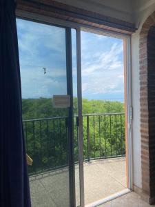 a sliding glass door with a view of a balcony at Casitas Las Palmas - Coral de Mar in Punta Mita