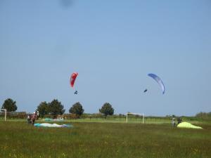a group of people flying kites in a field at Cottage in Central Bayeux in Bayeux