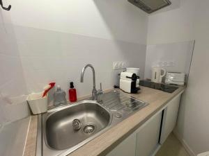 a kitchen counter with a sink in a room at Cottage in Central Bayeux in Bayeux +28 photos