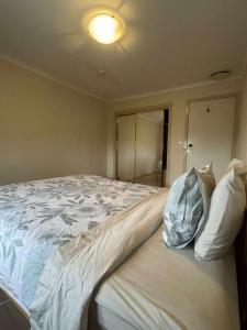 a bedroom with a large bed with a pillow on it at DoncasterRoom#nearCity&Freeway&Bus#WestfieldShoppingCentre in Doncaster