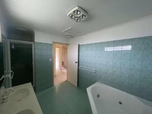 a bathroom with a tub and a sink and a shower at DoncasterRoom#nearCity&Freeway&Bus#WestfieldShoppingCentre in Doncaster