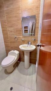 a bathroom with a toilet and a sink at Apartamento VIP LEO in Tacna +7 photos