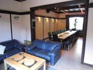 a living room with a couch and a table at Stay with Pool, Malmedy in Bévercé