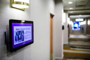a room with a wall with a screen on it at Crowne Plaza Hotel Dulles Airport, an IHG Hotel in Herndon