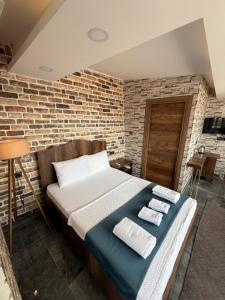 a bed in a room with a brick wall at La Vien Hotel Old City in Istanbul