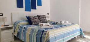a bedroom with a bed with towels on it at Dei Della Costiera in Agerola