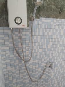 a shower with a hose attached to a tiled wall at Mateoasis in Ko Kood +288 photos