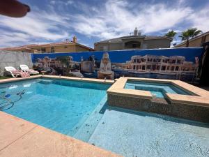 a large swimming pool in front of a house at Shadow Cove Property in Las Vegas +6 photos