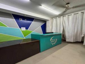 a room with a blue and green counter and curtains at Hotel O Shree hotels in Bhāgalpur