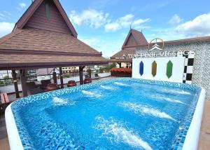 a swimming pool in front of a building at Tha Phae Village in Chiang Mai