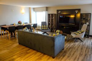 
a living room filled with furniture and a tv at Crowne Plaza Hotel Dulles Airport, an IHG Hotel in Herndon
