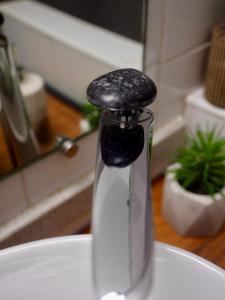 a glass bottle with a black top sitting on a table at SWEET HOME plage privée in Folle Anse +33 photos