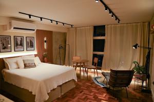 a bedroom with a bed and a table and chairs at Urban Studio in the historic center of São Paulo in Sao Paulo