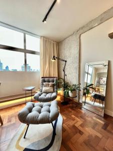 a living room with a couch and a chair at Urban Studio in the historic center of São Paulo in Sao Paulo