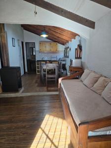 a living room with a couch and a dining room at Piccolo Paradiso in La Pedrera