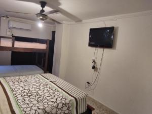 a bedroom with a bed and a flat screen tv at Apartamento Edificio Mara Rodadero in Rodadero