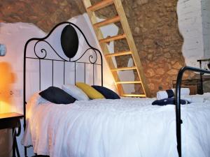a bedroom with a bed with a ladder on it at Holiday Home in Catalonia near Cala Pedrosa Beach in Girona