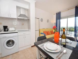 a kitchen and a living room with a table and a dining room at Apartment for 2 people in Roses with river view in Roses