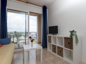 a living room with a couch and a tv at Apartment for 2 people in Roses with river view in Roses