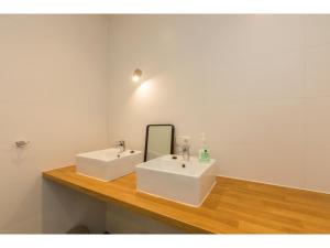 a bathroom with two sinks and a mirror on a counter at Holiday Home in Dishoek near Beach & Dunes in Dishoek +23 photos