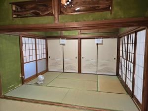 an empty room with glass doors and windows at いすみエンガワのある古民家 in Isumi