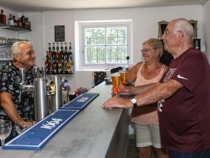 a group of people standing at a bar at Mobil-home 2 chambres avec terrasse - API-1-52-456 in La Mothe-Achard +13 photos