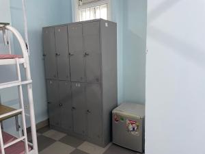 a locker room with gray lockers and a window at Cozy Dormitory House in Da Nang