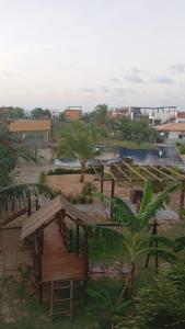 a view of a park with a playground and a pool at Pousada Village Gostoso in São Miguel do Gostoso
