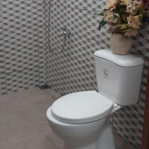 タバナンにあるThe Carik Homestayのバスルーム(花瓶付きトイレ付)