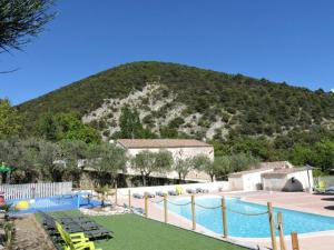 a large swimming pool with a mountain in the background at Mobil home 4 pers avec terrasse à Venterol - API-1-52-614 in Venterol