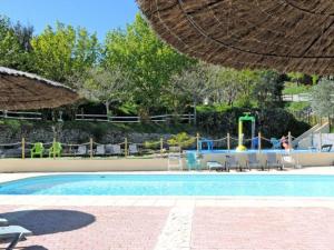 a swimming pool with a playground and an umbrella at Mobil home 4 pers avec terrasse à Venterol - API-1-52-614 in Venterol +19 photos