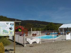 a fence around a swimming pool next to a tent at Mobil-home pour 4 pers avec terrasse - API-1-52-494 in Langogne