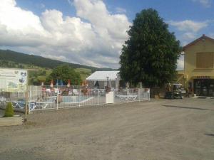 a fence in front of a building with a tent at Mobil-home pour 4 pers avec terrasse - API-1-52-494 in Langogne