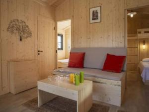 a room with a bench and a bed and a table at Chalet cosy avec terrasse - 2 chambres, 4 pers. - API-1-52-557 in Le Fouilloux