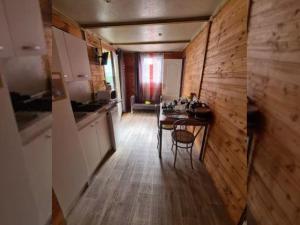 a kitchen with a table and a dining room at Chalet pour 5 pers avec Terrasse - API-1-52-634 in Les Grandes-Ventes
