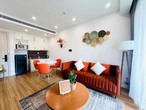 a living room with a couch and a table at SenSea Hillside Apartment - Sunset Town in Phu Quoc