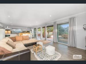 a living room with a couch and a table at Apartment in Axedale