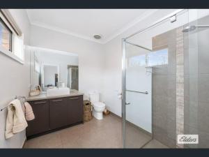 a bathroom with a glass shower and a toilet at Apartment in Axedale