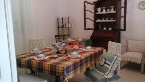 a dining room table with a plaid table cloth at B&B La casa del mugnaio di Capriata d'Orba in Predosa