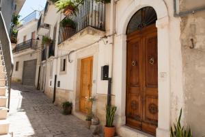 un vicolo con porte in legno su un edificio di Casa Giagantini a Scicli