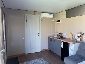 a small kitchen with a sink and a counter at Opensky-kolsay in Saty