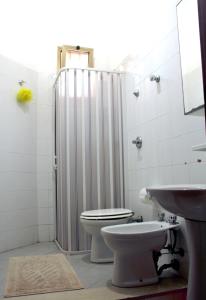 a bathroom with a shower and a toilet and a sink at Novecento in Trapani