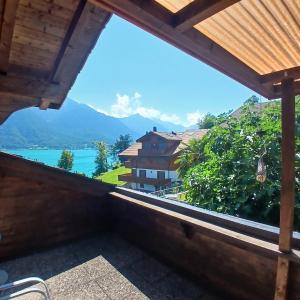 a balcony with a view of a lake and mountains at Chalet Diana Lakefront in Ringgenberg