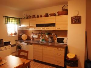 a kitchen with a sink and a microwave at Penzion u Ivana in Bořetice