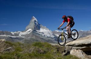 
a person riding a bike on top of a mountain at Hotel Garni Testa Grigia in Zermatt
