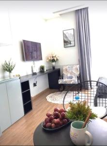 a room with a table with a plate of fruit on it at 5 Star Apt Studio, Swimming Pool, Gyms, Quick To Airport in Hanoi